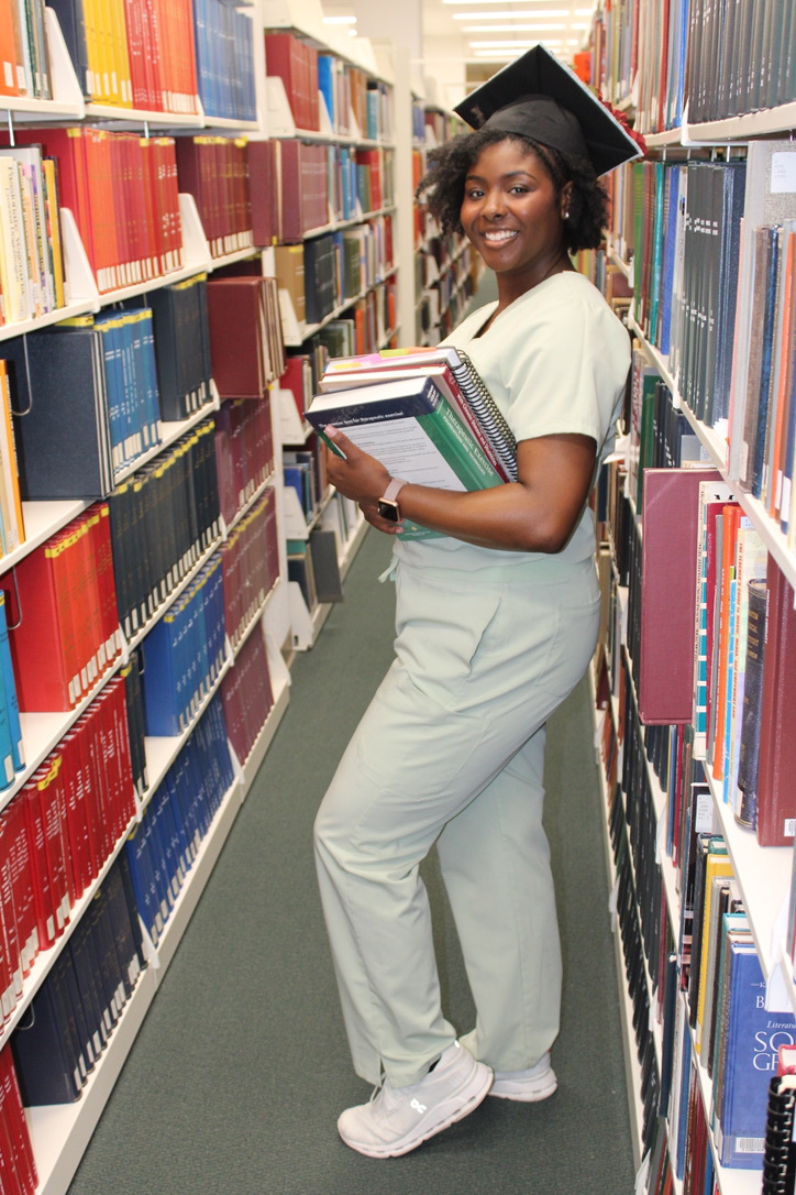 Naomi Anderson, a graduating kinesiotherapy student, finishes up last-minute studying in the library.

