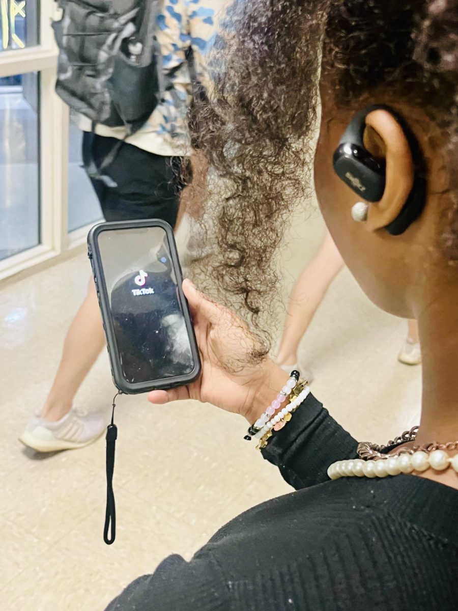 A USM student takes a TikTok break between classes.