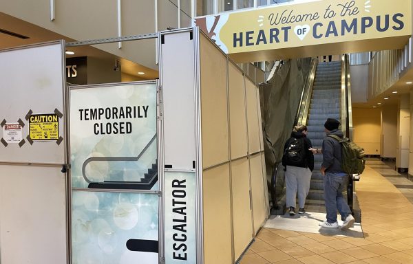 USM Students using the escalator beside the out -of-service one in the Thad Cochran Center. 
		
