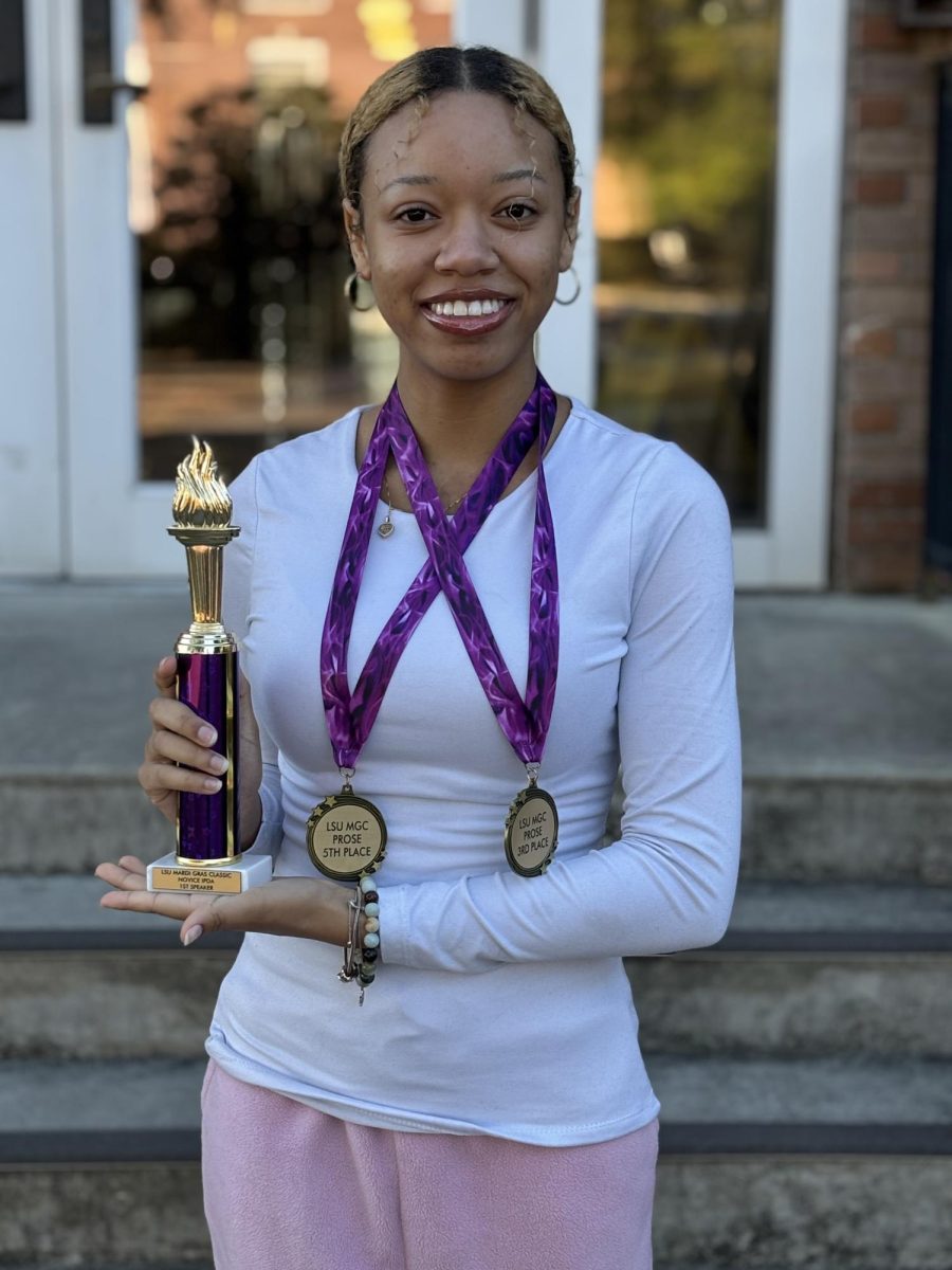 USM's Olivia Selenariveia poses with awards she won at a recent LSU speech and debate competition.