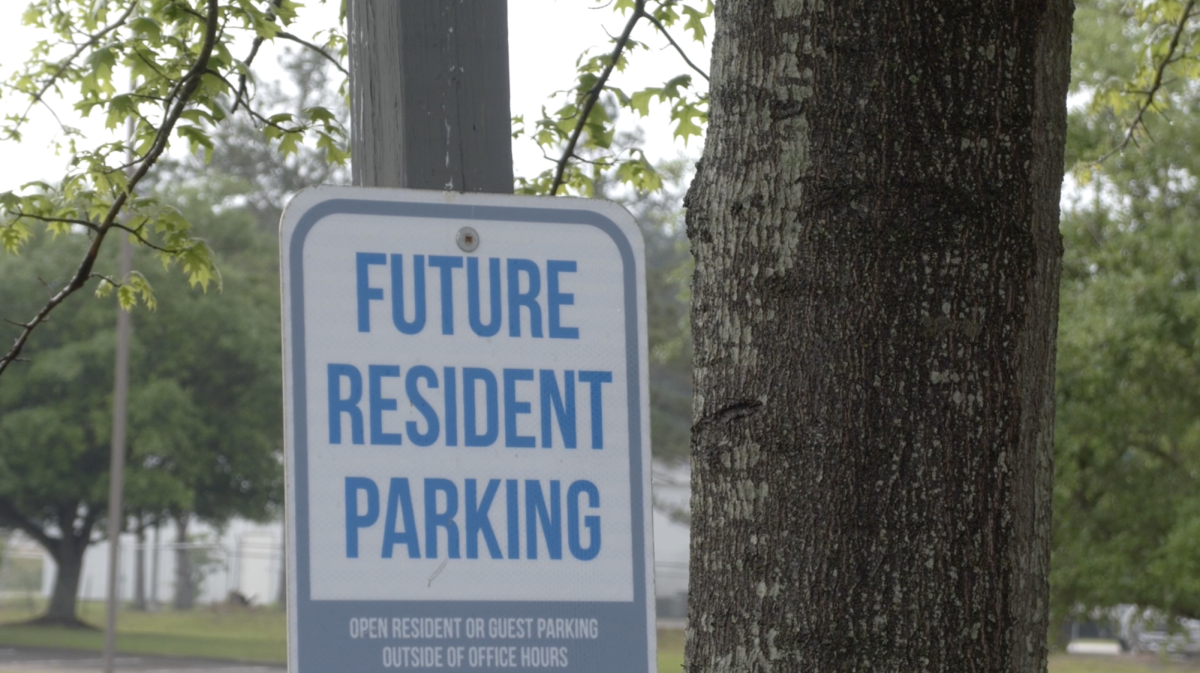 A sign showing parking for future residents at a local apartment complex.