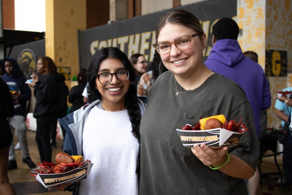 Two USM Students enjoy a crawfish feast at SMAC's Annual Crawfish Boil.