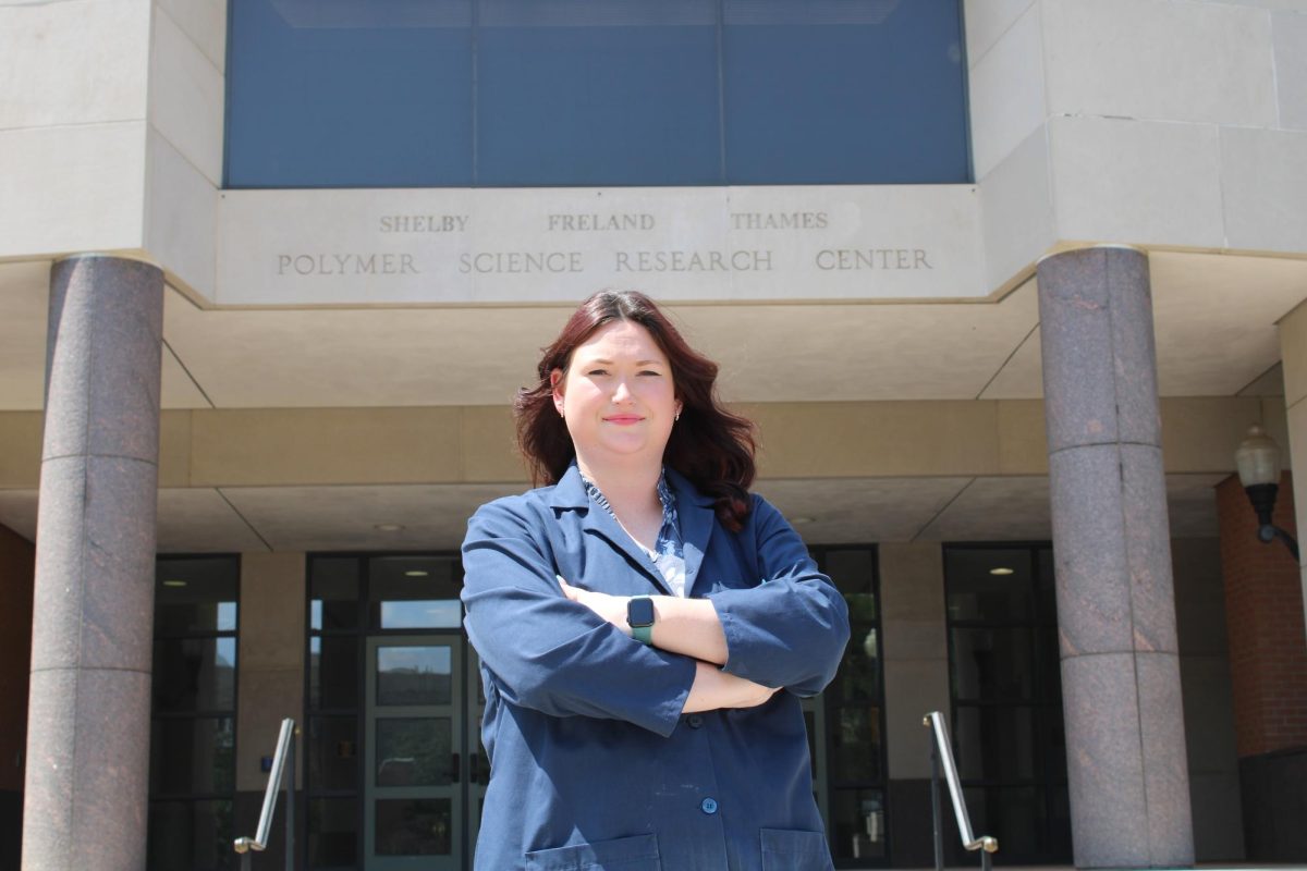 Emily Kilgore stands proudly in front of the Polymer Science building. 