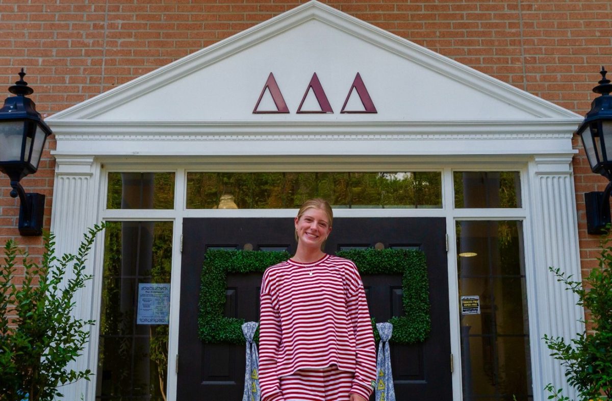 Caroline Del Rio, Tri Delta recruitment chair, in front of the Tri Delta house at USM.