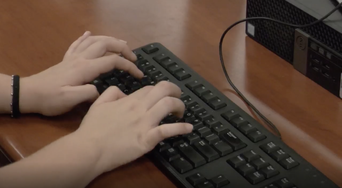 Student types on computer keyboard to Chat GPT.