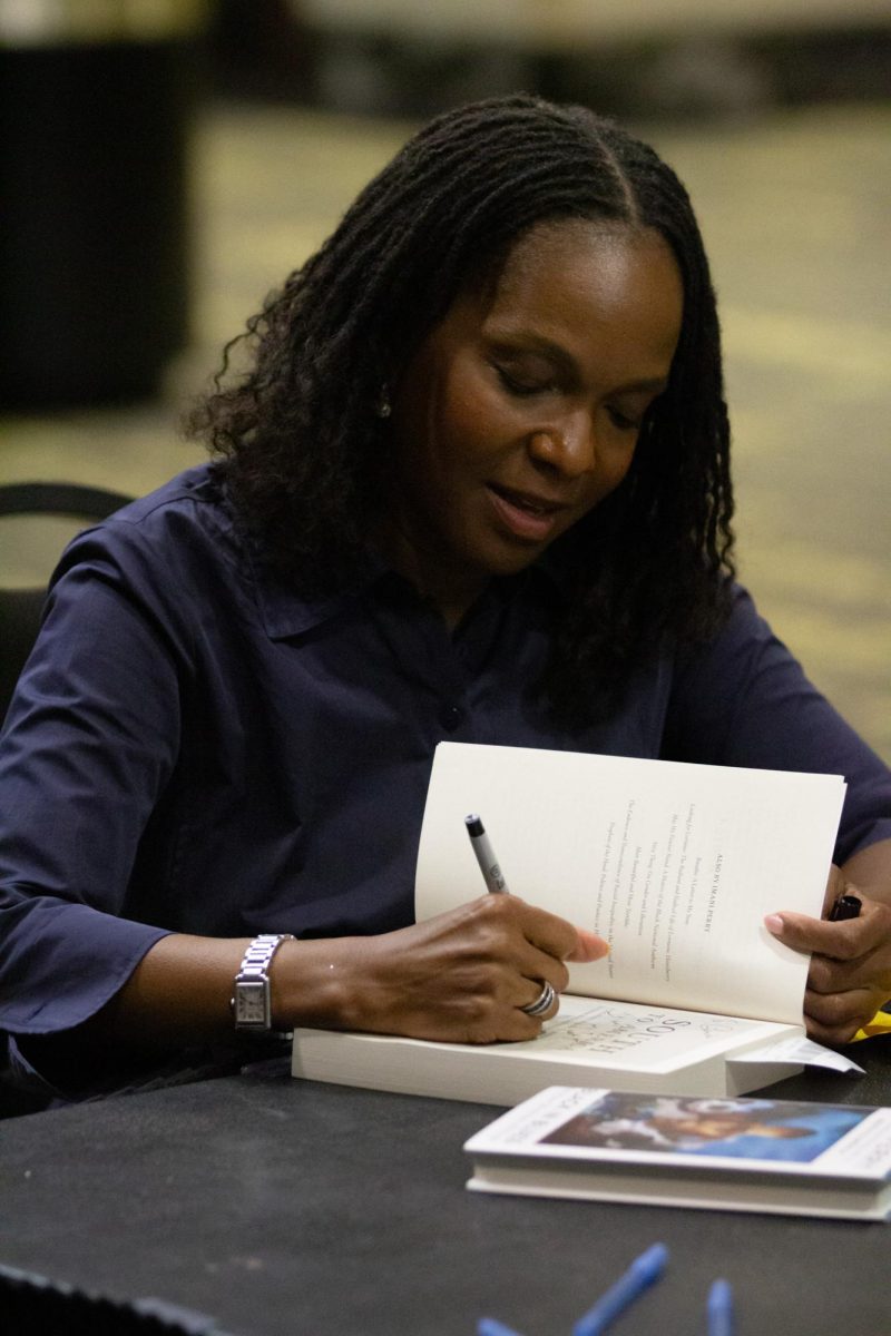 Imani Perry signing books after lecture.