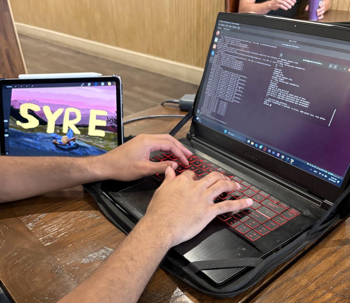Students working on coding while also drawing 