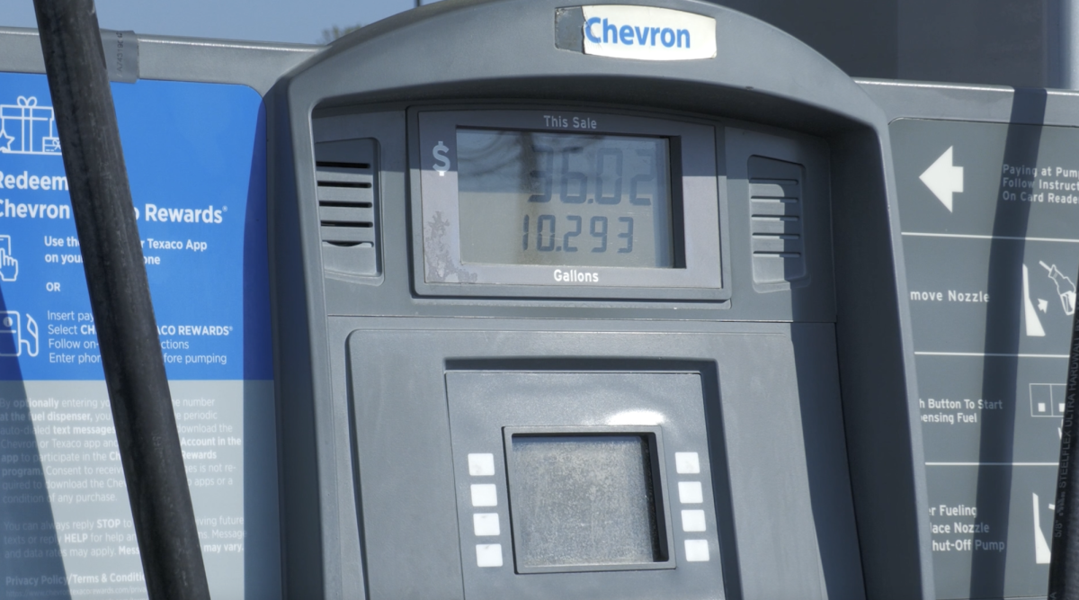 photo of gas prices and gallons as a student pumps gas