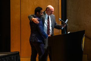 Dr. Jason Beverly presents Dr. Simpson with award.