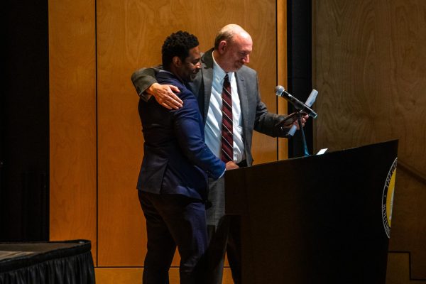 Dr. Jason Beverly presents Dr. Simpson with award.